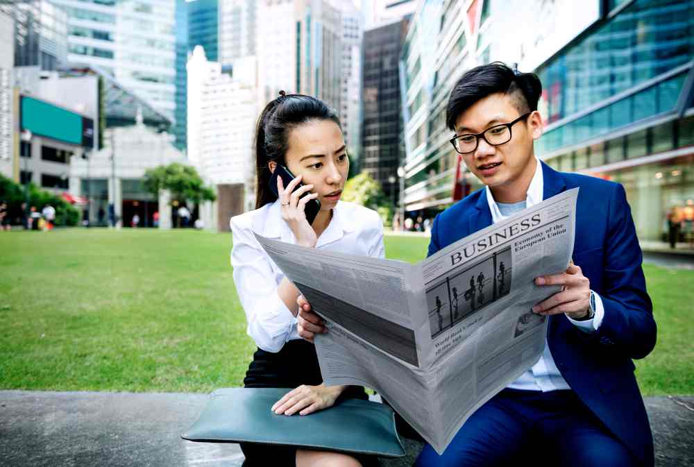 Two persons reading a press release