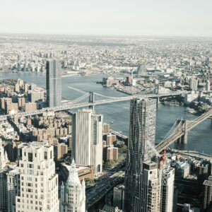 Aerial view of New York City showcasing the Brooklyn Bridge, Manhattan Bridge, and surrounding skyscrapers along the East River